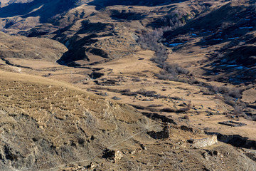 Distant view stone remains of old abandoned balkar village in North Caucasus
