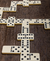 Dominoes game on old rustic wooden background. The concept of the game dominoes.