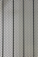 Background of the metal surface of the grid with uniform round holes and smooth lines
