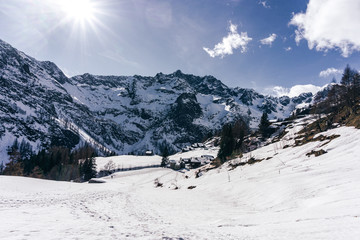 The snowy mountains of Valsesia seen from the val d'otro, during a sunny day near the town of Alagna, Italy - February 2020.