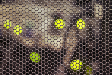 Background of a convex metal surface with round lattice holes and led lamp
