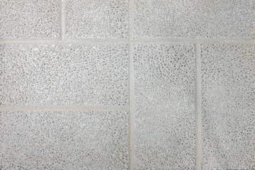 Fototapeta premium Tile with stone chips, close-up background