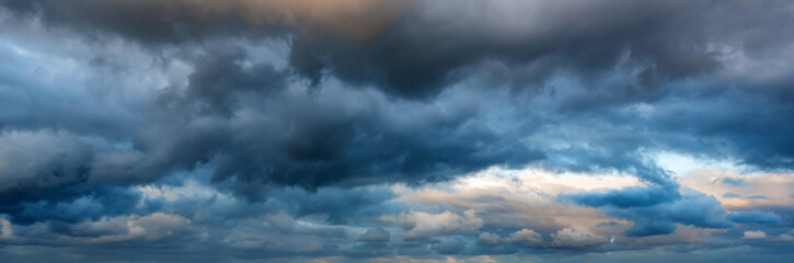 Dramatic panoramic skyscape with dark stormy clouds