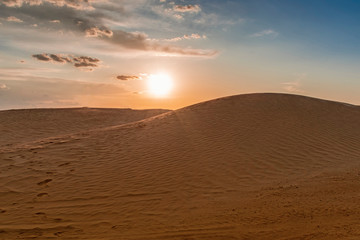 evening setting sun over the sand dunes in the Sahara desert