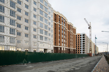 Construction site with houses in unfinished and finished stages