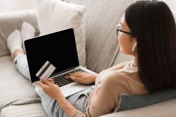 Girl making online purchase on laptop computer