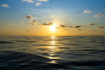 Sunset sky at the lake with motion wave and clouds