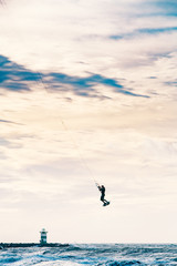 Kite surfing in storm in winter with extreme high jumps.