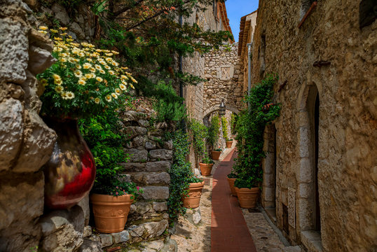 Fototapeta Old buildings on narrow streets in the medieval city of Eze Village in the South of France along the Mediterranean Sea