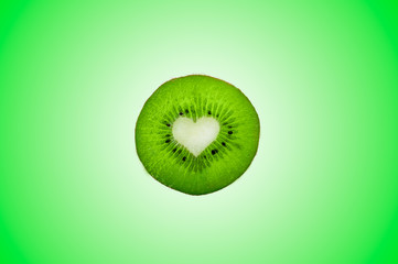 Green fruit kiwi close up with heart, green background. Kiwi fruit in the form of heart. Kiwi with...
