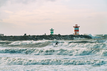 Kite surfing in storm in winter with extreme high jumps.