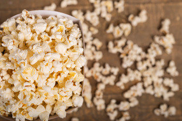 Popcorn bucket to enjoy the movie on wooden background. Top view