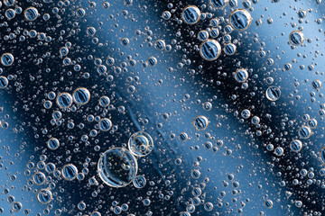 Large beautiful Oxygen bubbles underwater on a blue background macro. 