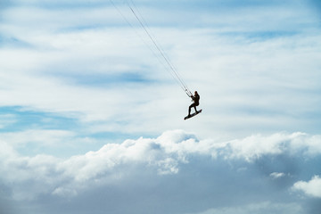 Kite surfing in storm in winter with extreme high jumps.