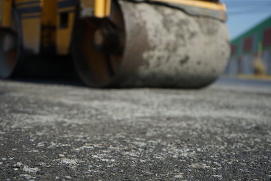 Blurred images of road roller maintenance work