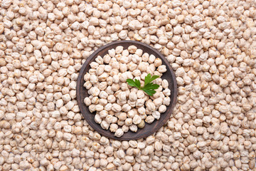 Chickpeas and wooden plate. Top view.