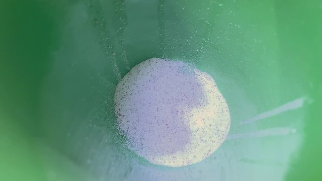 Closeup of white and brown instant coffee particles in a ceramic cup. Putting cappuccino powder into a white cup with a spoon. Making instant capuccino.