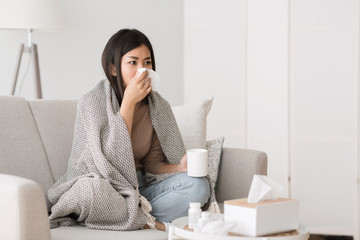 Cold and flu. Sick girl with runny nose drinking hot tea