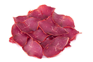 thinly sliced meat bacon made from beef, standing on white ground,
