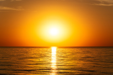 beautifun sunset on the beach with calm sea