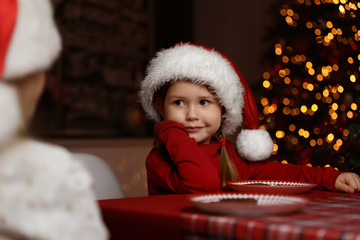 Cute little children at table in dining room. Christmas time