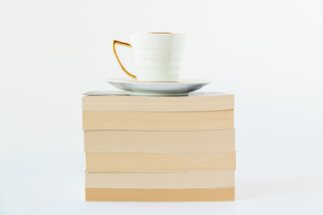 A cup of drink and stack of books.White background.Copy space.