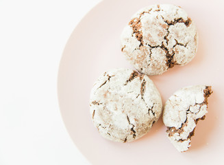 chocolate cookies on the pink plate.white minimalistic background.top view