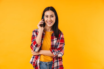 Image of pleased attractive woman smiling and talking cellphone