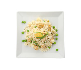 Delicious chicken risotto and lemon slices isolated on white, top view