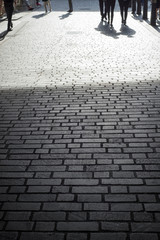 people walking down a cobbled lane