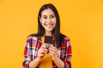 Image of cheerful caucasian woman smiling and holding chocolate