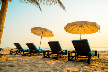 umbrella chair beach with palm tree and sea beach at sunrise times