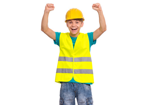 Funny Handsome Teen Boy wearing Safety Jacket and yellow Hard Hat having fun. Portrait of Happy smiling Child with outstretched hands Looking at camera, isolated on white background.
