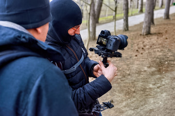 Photographer and a man in late winter forest