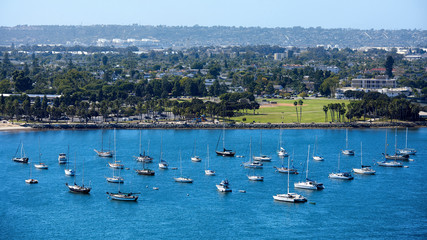 Sailing boats in waterfront area. Cityscape on background