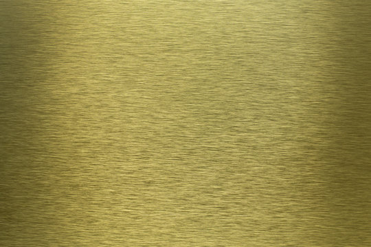 High quality image of old golden metal brushed surface with light reflection background
