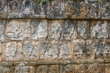 The Tzompantli, or Skull Platform (Plataforma de los Craneos). Chichen Itza archaeological site. Architecture of ancient maya civilization. Travel photo or wallpaper. Yucatan. Mexico.