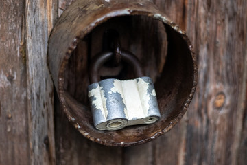 Old door lock and rusty metal rim close-up.