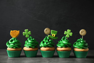 Delicious decorated cupcakes on grey table. St. Patrick's Day celebration