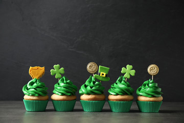 Delicious decorated cupcakes on grey table. St. Patrick's Day celebration