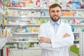Fototapeta na wymiar Portrait of professional pharmacist in modern drugstore. Space for text