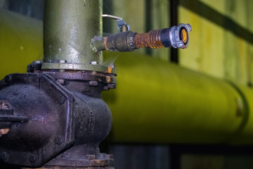 The mechanism for connecting a fire hydrant to a water tap. Close-up.