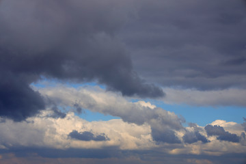 Sky background with dense clouds lit by the sun.