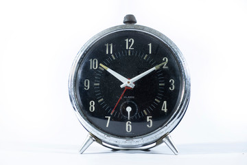 Classic style black table clock isolated on a white background.