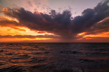 Beautiful landscape. Bright sunset with dramatics clouds over the lake. 