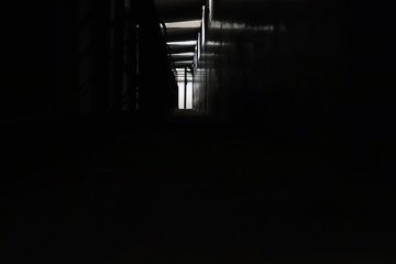 Dark tunnel with glimmers of light. Type of perspective.