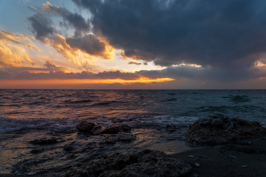 Beautiful landscape. Bright colorful sunset with dramatics clouds over the lake. 