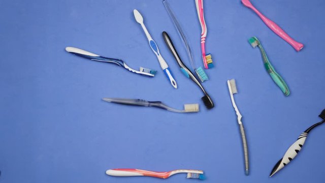 Used plastic toothbrushes thrown away. Plastic waste problem. Trash added to landfills and pollute our oceans. Stop motion