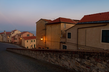 Fototapeta na wymiar Night scene in the old town of Imperia, seaside city on the Italian Riviera