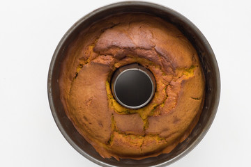 Top view of baked pumpkin cake in bundt pan on the white background